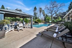 a patio with a table and chairs and a pool at La Rinconada Place in Redding