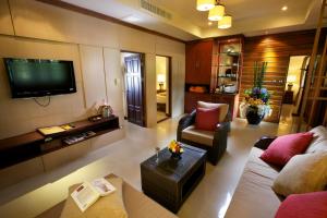 a living room with a couch and a tv at Smile House - Fisherman Village in Bophut