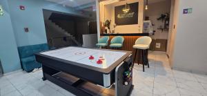 a room with a ping pong table in a store at CLUB 33 FIT Hotel Gym in Huancayo