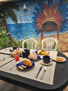 a table with plates of food on top at Recanto D'Ajuda in Arraial d'Ajuda +16 photos