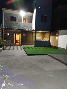 a house with a lawn in front of it at Casa da Josse in Camaçari