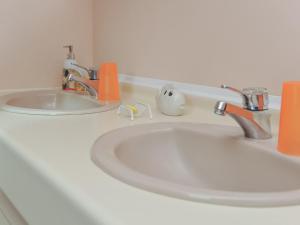 a bathroom sink with two faucets on a counter at Gîte indépendant près du centre-ville - Animaux acceptés, Parking privé, Wifi - FR-1-510-236 in Steenvoorde +27 photos
