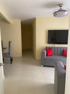 a living room with a couch and a table at Urban charm in Santo Domingo