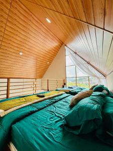 un groupe de lits dans une pièce avec un plafond en bois dans l'établissement Arutala Villa tiitk 0 Dieng View Pegunungan, à Diyeng