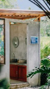 a small kitchen with a sink and a mirror at PukuPods - Tent & Cabin in Tabanan +56 photos