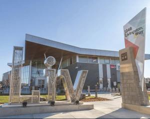 a building with a sculpture in front of it at Luxury Haven by Kc & Flo in YYC