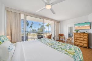 a bedroom with a bed and a view of the ocean at Island Surf 306 · ISF 306 1BD w Ocean Views AC Pool Near Beach in Kihei +49 photos