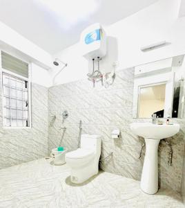 a bathroom with a toilet and a sink at Hotel Swagat in Pelling +15 photos