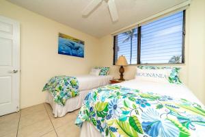 a bedroom with two beds and a window at Kihei Akahi D402 · AKH D402 2BD Condo Across Beach Ocean View AC in Wailea +43 photos