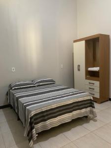 a bedroom with a bed and a dresser at Large and comfortable house in the new Maraba - Folha 16 in Marabá