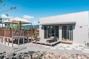a house with a deck and a bench at Fuji Private Villa FUU-KUU in Fujiyoshida
