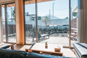 a living room with a couch and a table at Fuji Private Villa FUU-KUU in Fujiyoshida