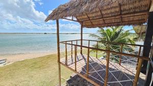 a view of a beach with a hut and the water at Toca da Ilha in Itarema