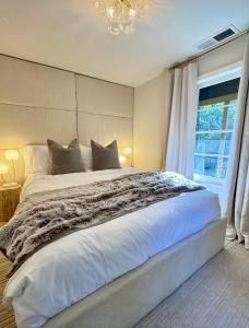 a bedroom with a large white bed and a window at Modern Farmhouse at Montaluce Winery in Dahlonega