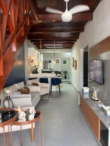 a living room with a couch and a table at Condominium Village V Praia dos Carneiros-PE in Tamandaré