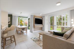 a living room with a couch and a table at Coral Coast Resort Accor Vacation Club Apartments in Palm Cove