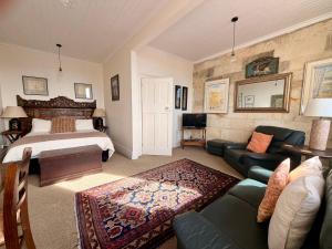 a living room with a bed and a couch at The Whitestone in Oamaru