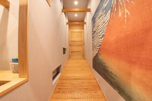 a long hallway with a painting on the wall at Fuji Private Villa FUU-KUU in Fujiyoshida