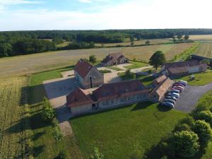 an aerial view of a large house in a field at Gîte La Huzarde: Havre de paix en nature, Allier - FR-1-489-599 in La Faye
