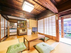 a living room with a table and a couch at Kokoyui - Vacation STAY 06794v in Shimosato