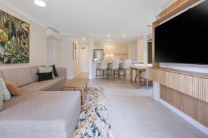 a living room with a couch and a flat screen tv at Coral Coast Resort Accor Vacation Club Apartments in Palm Cove +21 photos