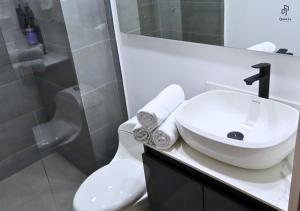 a white bathroom with a sink and a toilet at Quinta Park 43 in Bogotá +46 photos