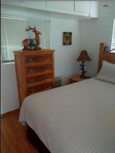 a bedroom with a bed and a dresser with a horse on it at Redrockescapes in Sedona