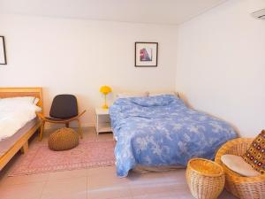 a bedroom with a bed and a table and a chair at Hongcheon Riverhill Stay in Torung-gol
