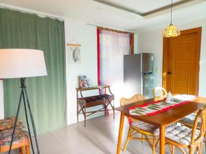 a kitchen with a table and a dining room at Hongcheon Riverhill Stay in Torung-gol