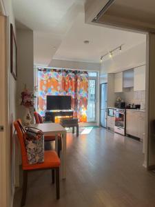 a living room with a table and a kitchen at Cozy holiday home in Toronto