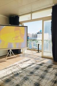 a large screen in a room with a large window at Cozynest Homestay n Cinema in Ho Chi Minh City
