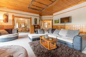 a living room with couches and a table at Hatuma Paradise in  Waipukurau