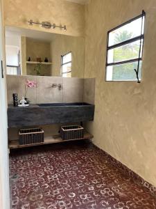 a bathroom with a sink and a mirror at Las Marias in San Fernando del Valle de Catamarca +16 photos