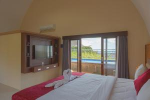 a bedroom with a bed with towels on it at Blue Oceana Villa in Nusa Dua