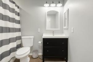 a bathroom with a toilet and a sink and a mirror at OldTown, Splash Pad & Park, Camelback Mountain trails, Desert Chic Retreat in Scottsdale +11 photos