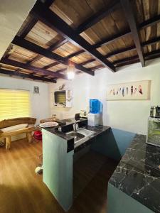 a kitchen with a sink and a counter top at Paradiso Hostel El nido in El Nido +60 photos