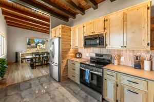 a kitchen with wooden cabinets and stainless steel appliances at 1 Block from Main St Views Pets Okay in Leadville