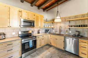 a kitchen with wooden cabinets and stainless steel appliances at 1 Block from Main St Views Pets Okay in Leadville +12 photos