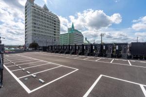 a parking lot with a row of train cars at HOTEL R9 The Yard Kasama in Tomobe