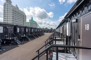 a row of train cars parked next to a building at HOTEL R9 The Yard Kasama in Tomobe