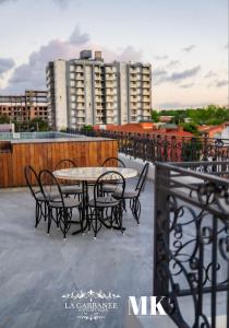 a table and chairs on the roof of a building at La Gabbanee Hotel Boutique in Fernando de la Mora
