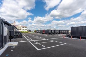 an empty parking lot with a bunch of trailers at HOTEL R9 The Yard Kasama in Tomobe