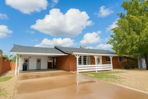 a brick house with a driveway in front of it at OldTown, Splash Pad & Park, Camelback Mountain trails, Desert Chic Retreat in Scottsdale