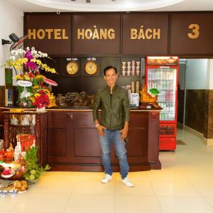 a man standing in front of a hotel hong beach at Hoàng Bách 3 Hotel in Ho Chi Minh City