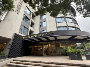 a building with a sign on the front of it at Mercure Nanjing Hongshan in Nanjing