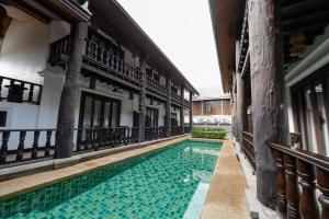 a swimming pool in the courtyard of a building at Treasure Heritage Luang Prabang Hotel in Luang Prabang