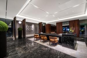 a lobby with chairs and a bar in a building at 上海虹桥中心城际酒店 in Shanghai