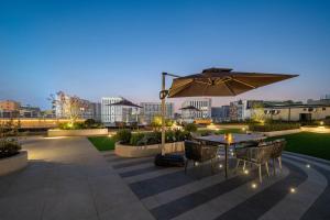 a patio with an umbrella and a table and chairs at 上海虹桥中心城际酒店 in Shanghai