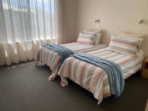 Emu BayにあるBirubi Holiday Homes Kangaroo Islandの窓のある部屋にツインベッドが2台