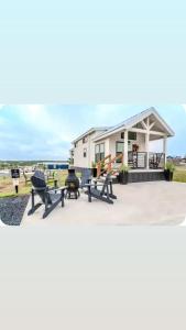 a house with picnic tables and chairs in front of it at Moonlight Views #54 Firefly Resort in Fredericksburg
